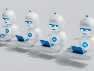 a group of white robots sitting on top of laptops