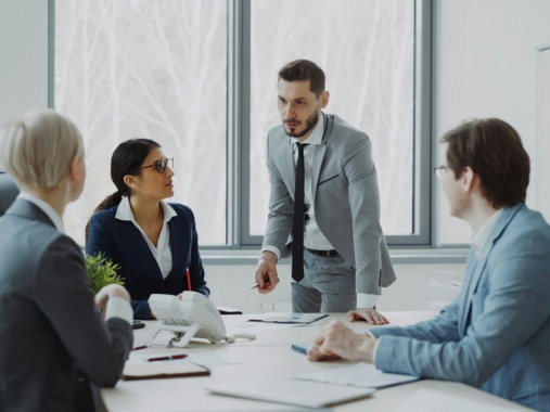 Business professionals in a meeting around a table.