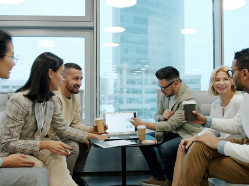 Diverse group of people in a modern office meeting.